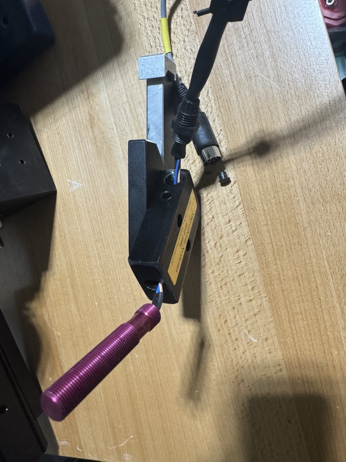 DISP inductive sensor, with its blue/brown/black wires showing