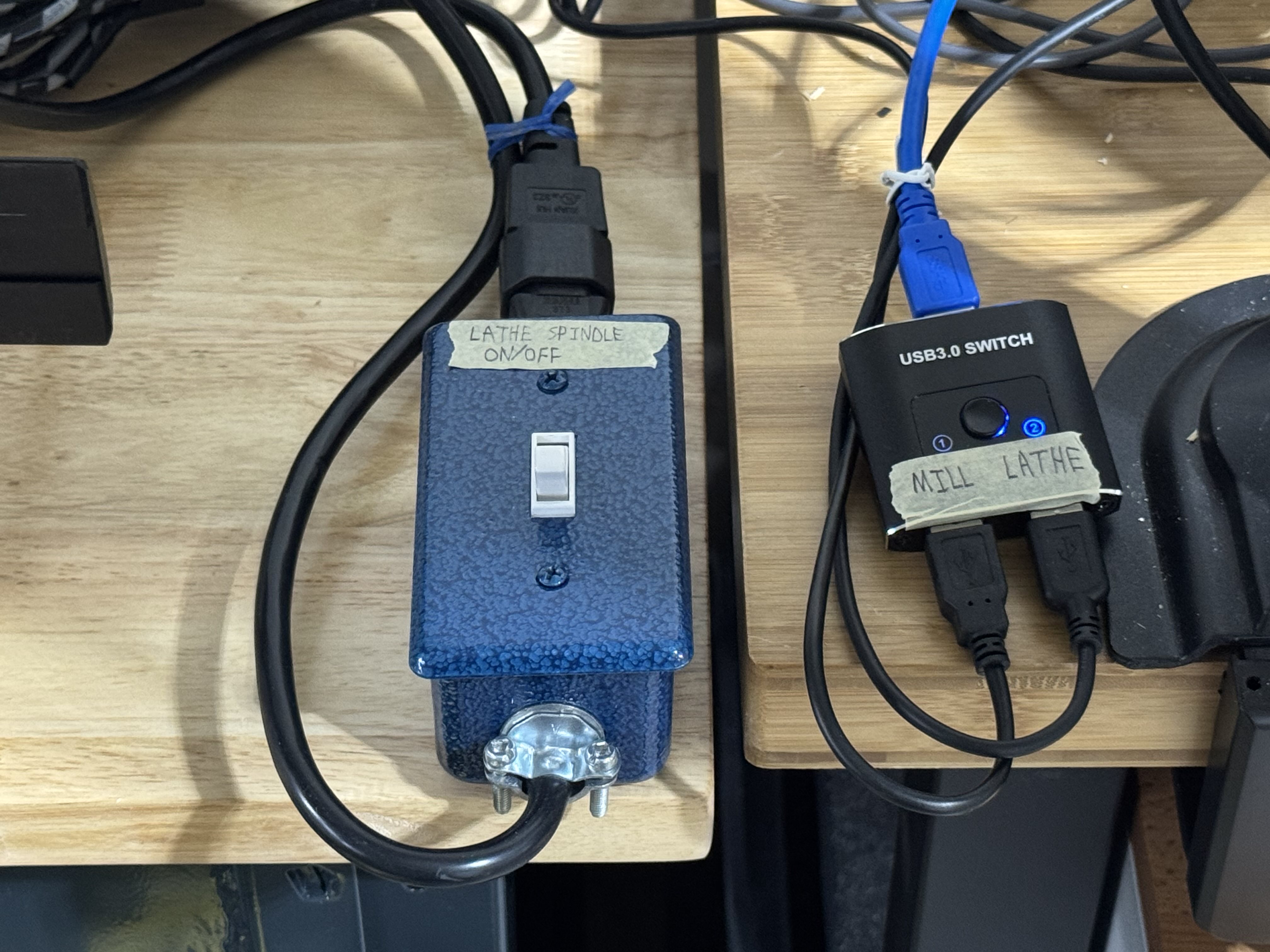 USB switcher to select between two UC100s, to the right of the spindle on/off switch