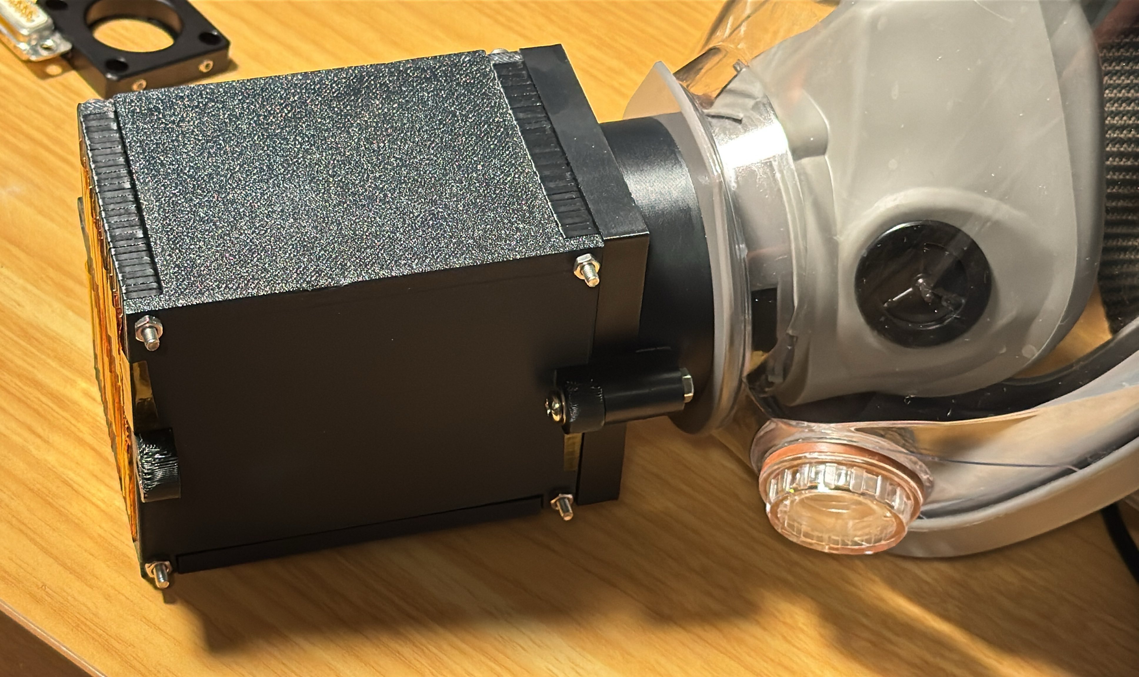 Full-face respirator with heat exchanger attached